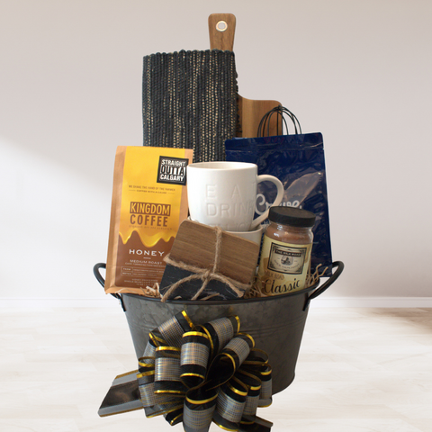 Taste of home gift basket. Coffee, hot chocolate, cupcake mix, mugs, coasters, placemat, charcuterie board, calgary gift basket