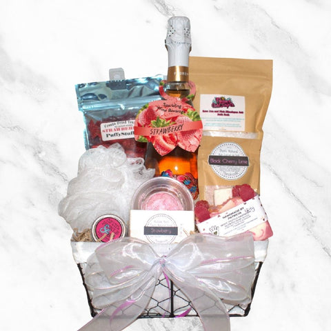 Berry Spa Gift Basket featuring local products. Bar of soap, freeze dried strawberries, lip balm, bath salts, bottle of strawberry wine