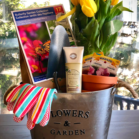 Flowers and gardens gift basket calgary, gift basket containing gardening supplies such as a hand shovel, terracotta pot, flower seeds, a fresh bouquet of tulips, lily bulbs and hand lotion and gloves.  